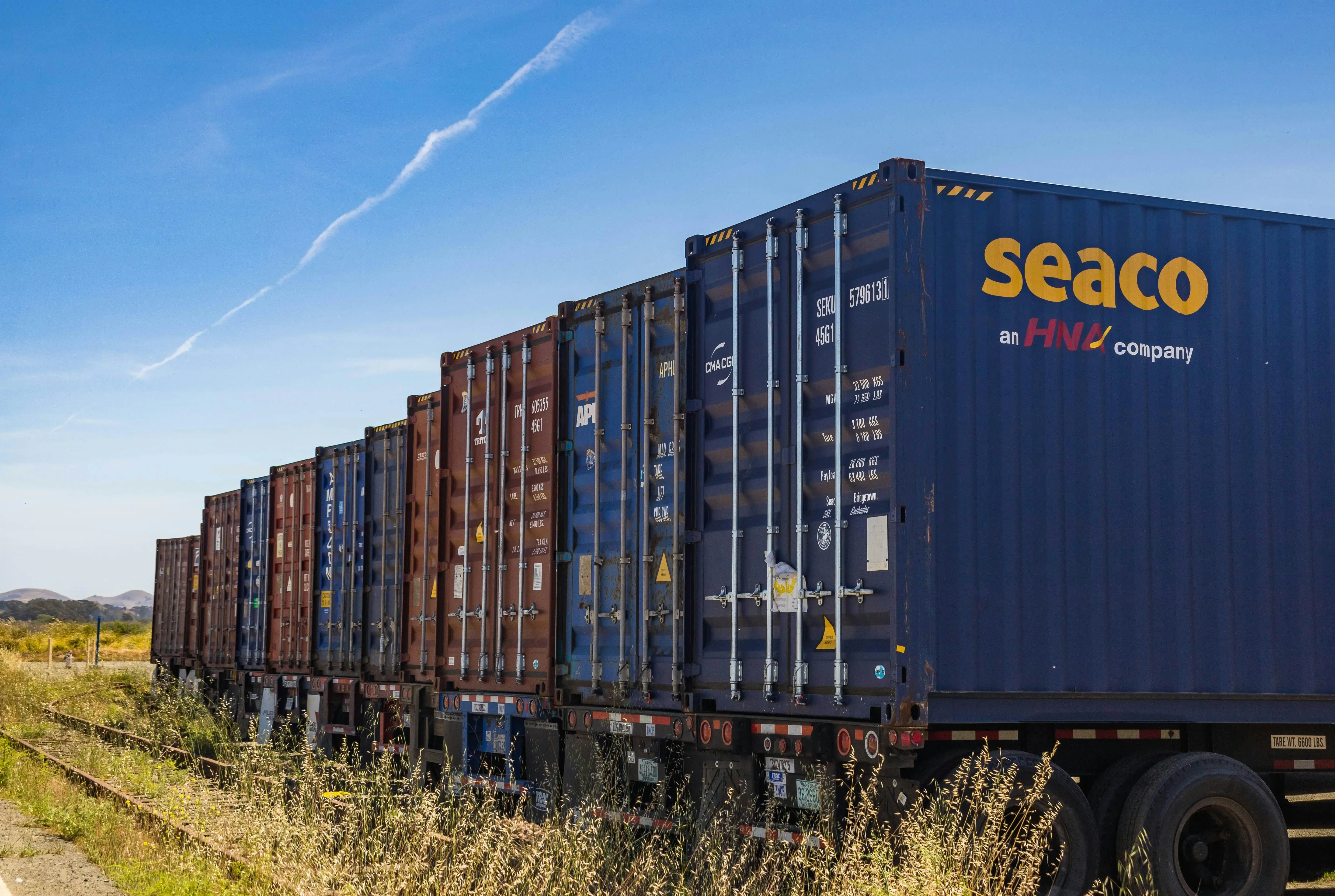 Shipping containers on train cars